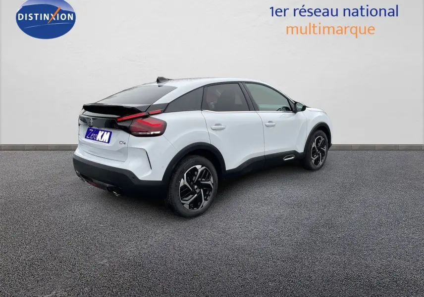 Citroën C4 blanc métal vue 3/4 arrière droit avec toit noir et jantes alliage bicolores.