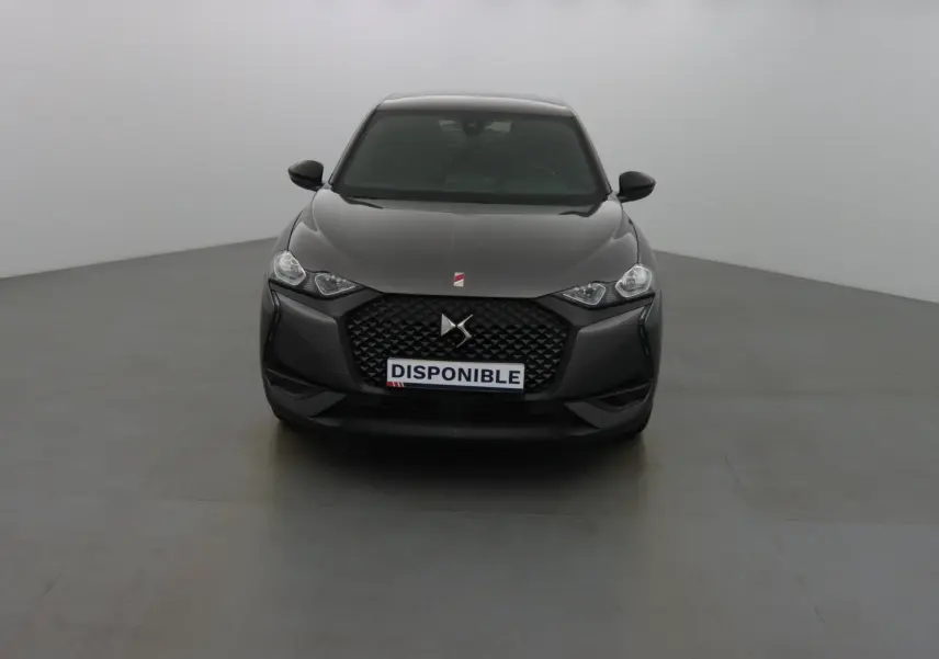 Vue frontale d'un DS3 Crossback gris platinium métal avec calandre noire et phares LED allumés.
