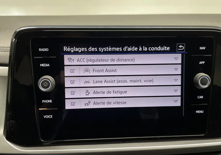 Écran tactile central du Volkswagen T-Roc 2024 affichant les réglages des aides à la conduite.