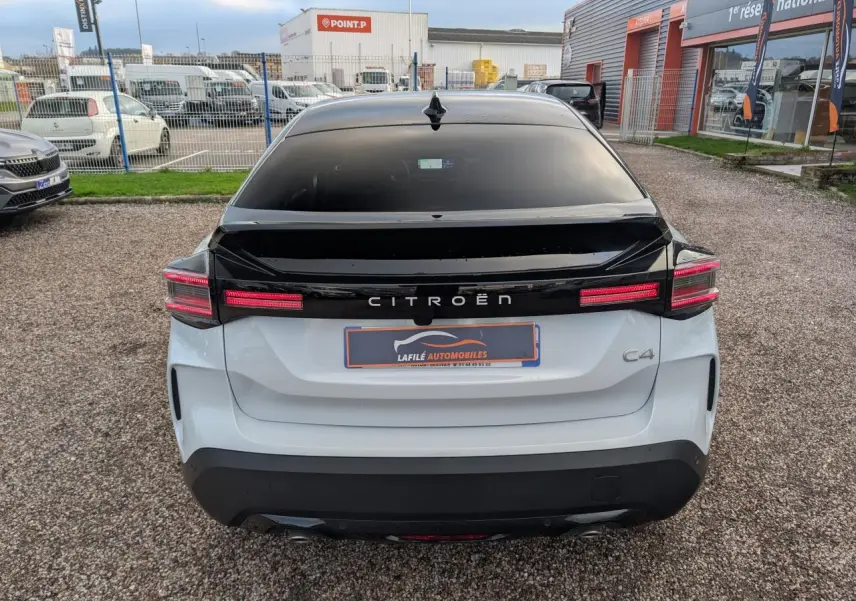 Vue arrière d'une Citroën C4 blanche avec toit noir Perla Nera et feux arrière LED distinctifs.