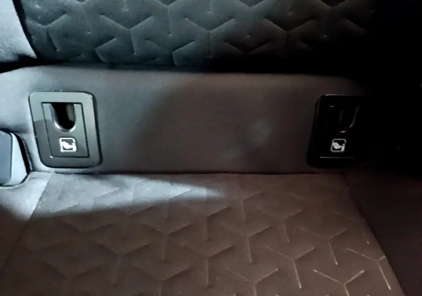 Détail des attaches Isofix sur la banquette arrière en tissu gris foncé du Suzuki Swace 1.8 Hybrid Privilege.