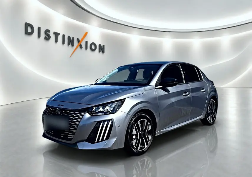 Peugeot 208 gris Artense vue 3/4 avant droit, avec phares LED et jantes alliage distinctives.