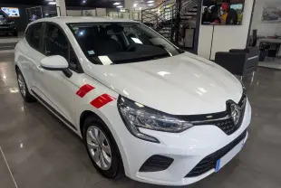 Renault Clio V blanche vue en 3/4 avant droit avec bandes rouges sur l'aile, exposée en showroom.