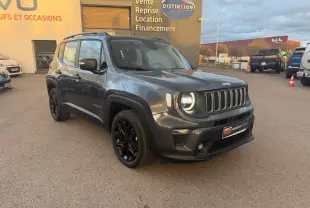Jeep Renegade gris anthracite en 3/4 avant droit, avec jantes alliage noires et barres de toit visibles.