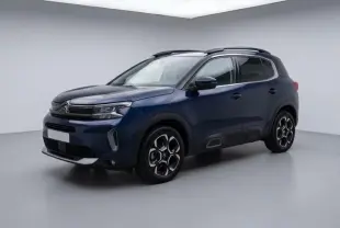 Citroën C5 Aircross hybride 2024 bleu foncé, vue 3/4 avant droit avec jantes au design hexagonal distinctif.