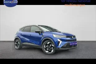 Renault Captur 2025 hybride bleu Iron avec toit noir, vue 3/4 avant mettant en valeur ses jantes alu bicolores.