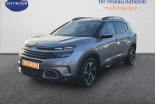 Citroën C5 Aircross gris Artense métal en 3/4 avant droit, SUV compact avec jantes bicolores et barres de toit.