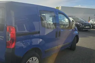 Peugeot Bipper bleu vue 3/4 avant droit sur route, avec large pare-chocs noir et phares arrondis.