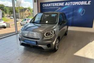 Vue 3/4 avant d'une LEAPMOTOR T03 électrique gris acier avec toit noir, exposée en showroom lumineux.