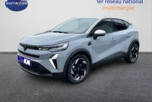 Renault Captur 2025 gris Rafale métal avec toit beige, vue 3/4 avant droit mettant en valeur ses jantes noires stylisées.