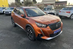 Peugeot 2008 orange fusion vue 3/4 avant droit, avec calandre noire et jantes alliage noires et argentées.
