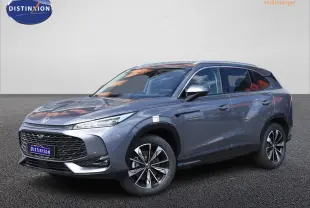 MG Motor EHS gris en 3/4 avant droit, avec jantes alliage noires et phares LED fins, sur fond neutre.
