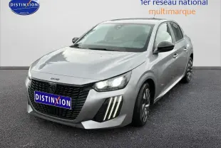 PEUGEOT 208 gris artense en 3/4 avant droit, avec phares allumés et feux diurnes à LED verticaux visibles.