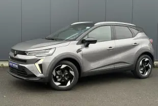 Renault Captur 2025 gris Cassiopée et noir, vue 3/4 avant droit, jantes alu diamantées noires et railing de toit alu.