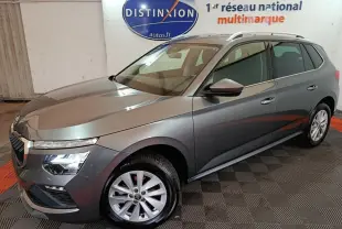 Vue 3/4 avant droit d'un Skoda Kamiq gris clair avec phares LED et jantes alliage dans un showroom.