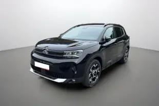 Citroën C5 Aircross Hybrid noir en 3/4 avant droit, avec barres de toit et jantes alu 18 pouces visibles.