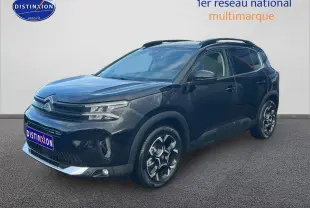 Citroën C5 Aircross noir vue 3/4 avant droit avec jantes alu et barres de toit visibles.