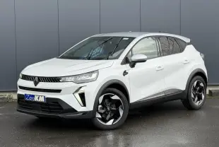 Renault Captur 2025 blanc nacré en 3/4 avant droit avec jantes noires et toit gris Highland visible.