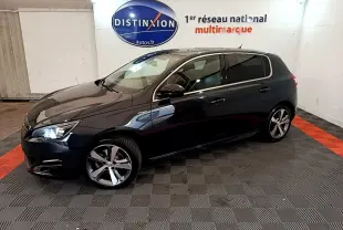Peugeot 308 1.2 PureTech GT Line gris foncé vue de profil côté gauche en intérieur showroom avec logo Distinxion.