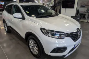 Renault Kadjar blanc glacier vu en 3/4 avant droit dans un showroom avec phares LED et jantes alliage.