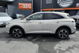 Vue latérale droite d'un DS7 Crossback gris métallisé 2022 avec jantes alliage noires et vitres teintées.