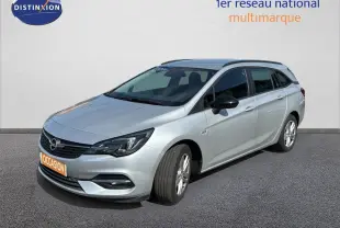 Opel Astra Sports Tourer gris minéral métal vue 3/4 avant droit sur fond neutre avec calandre noire.