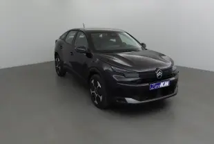 Citroën C4 1.2 Hybrid 145 noir vue 3/4 avant dans un studio, avec calandre noire et jantes stylisées.