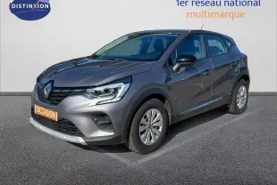 Renault Captur TCE 100CH Corporate Edition gris cassiopée métal en 3/4 avant droit sur sol bitumé.