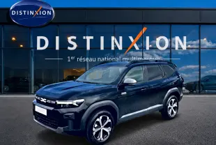 SUV Dacia Bigster noir en 3/4 avant droit, avec jantes alliage diamantées et rétroviseurs argentés, devant showroom Distinxion.