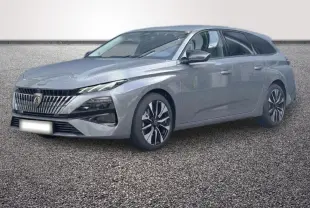 Peugeot 308 Hybrid gris foncé vue 3/4 avant, avec calandre verticale et jantes bicolores distinctives.