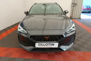 Vue frontale d'une CUPRA LEON ST 1.5 eTSI gris foncé avec phares LED et calandre noire distinctive.