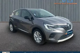 Renault Captur TCe 100 Business gris vu en 3/4 avant droit, avec phares LED et jantes alliage visibles.