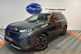 Peugeot 5008 Hybrid gris titane en 3/4 avant droit, avec jantes noires et phares LED allumés.