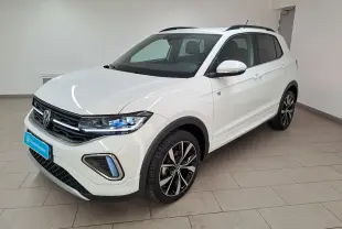 Vue de profil côté gauche du Volkswagen T-Cross blanc pur 2025 R-Line avec jantes alliage noires et toit noir.